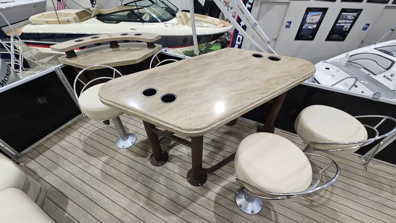 Slide: The Image of 2019 SunChaser Eclipse 8525 Entertainer boat interior with table and swivel chairs. - 12