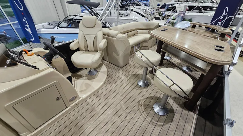 Slide: The Image of 2019 SunChaser Eclipse 8525 Entertainer boat interior with seating and table setup. - 13