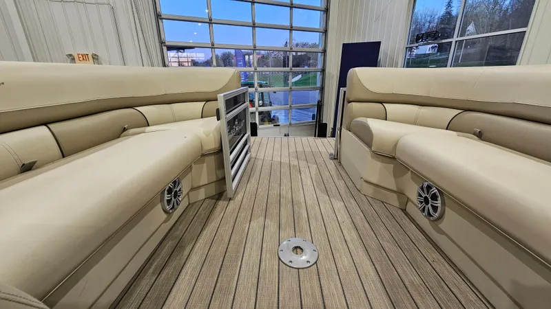 Slide: The Image of 2019 SunChaser Eclipse 8525 Entertainer boat interior with beige seating and wood-style flooring. - 19
