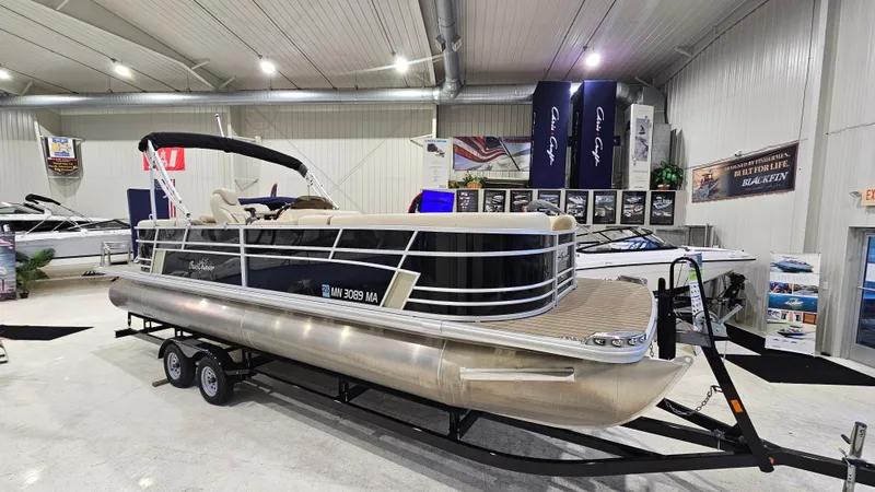 Slide: The Image of 2019 SunChaser Eclipse 8525 Entertainer pontoon boat displayed indoors on a trailer. - 2