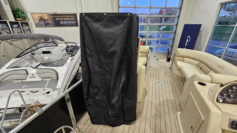 Slide: The Image of 2019 SunChaser Eclipse 8525 Entertainer boat in showroom with luxury seating and modern design. - 22