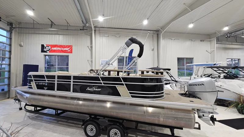 Slide: The Image of 2019 SunChaser Eclipse 8525 Entertainer pontoon boat displayed indoors on a trailer. - 4