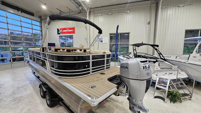 Slide: The Image of 2019 SunChaser Eclipse 8525 Entertainer pontoon boat in showroom with Honda 150 outboard motor. - 5