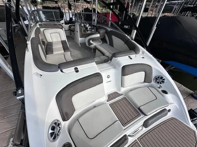 Slide: The Image of 2012 Yamaha Boats 242 Limited S with spacious seating and modern design in a marina setting. - 10