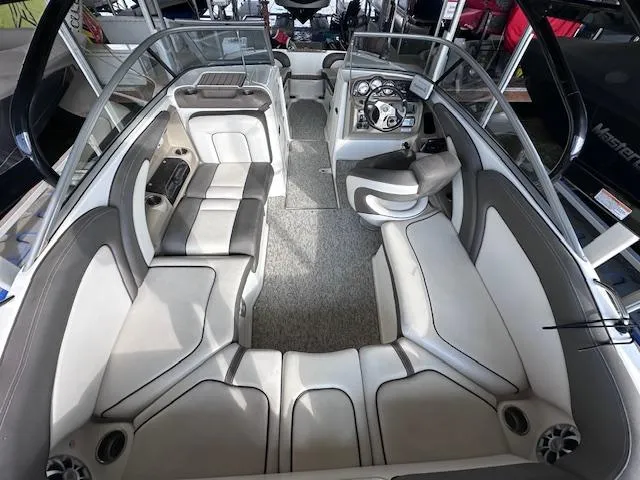 Slide: The Image of Interior of a 2012 Yamaha Boats 242 Limited S, featuring spacious seating and modern dashboard. - 11