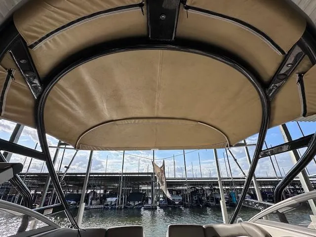 Slide: The Image of 2012 Yamaha Boats 242 Limited S with canopy, docked at marina. - 19