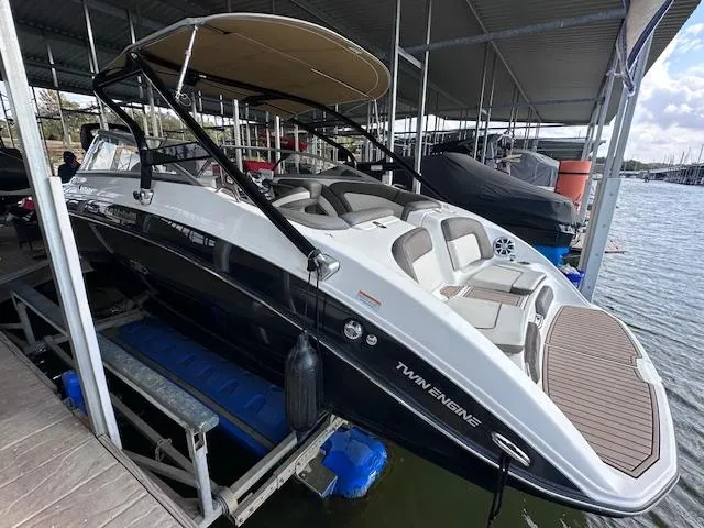 Slide: The Image of 2012 Yamaha Boats 242 Limited S docked, featuring sleek design and twin engines. - 2