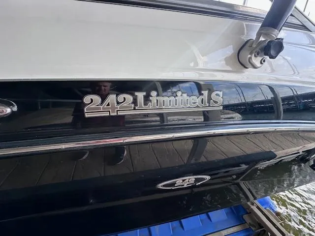 Slide: The Image of 2012 Yamaha Boats 242 Limited S, docked, close-up of model name on hull. - 3