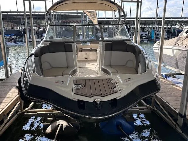Slide: The Image of 2012 Yamaha Boats 242 Limited S docked, showcasing spacious seating and sleek design. - 7