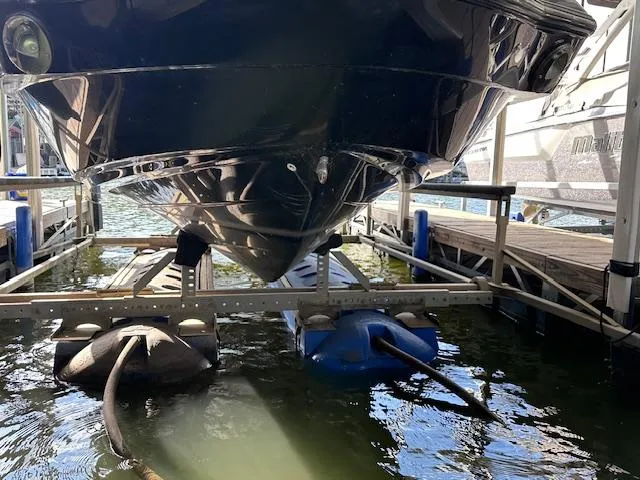 Slide: The Image of Yamaha Boats 2012 242 Limited S on a lift, docked over water. - 8