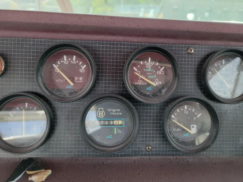 Slide: The Image of Dashboard gauges of a 1989 Sea Ray 340 Sundancer boat. - 11