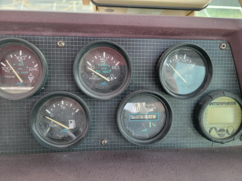Slide: The Image of Dashboard gauges of a 1989 Sea Ray 340 Sundancer boat. - 13