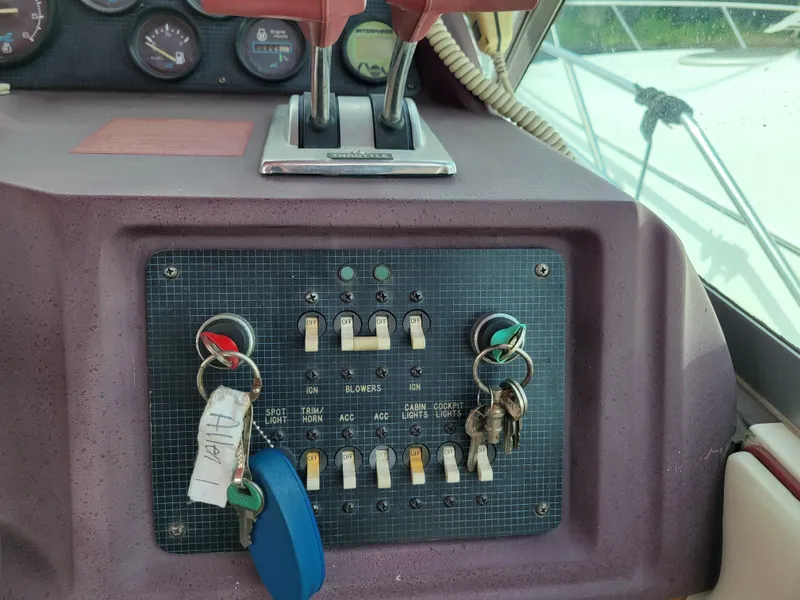 Slide: The Image of Control panel of a 1989 Sea Ray 340 Sundancer boat with keys and switches. - 15
