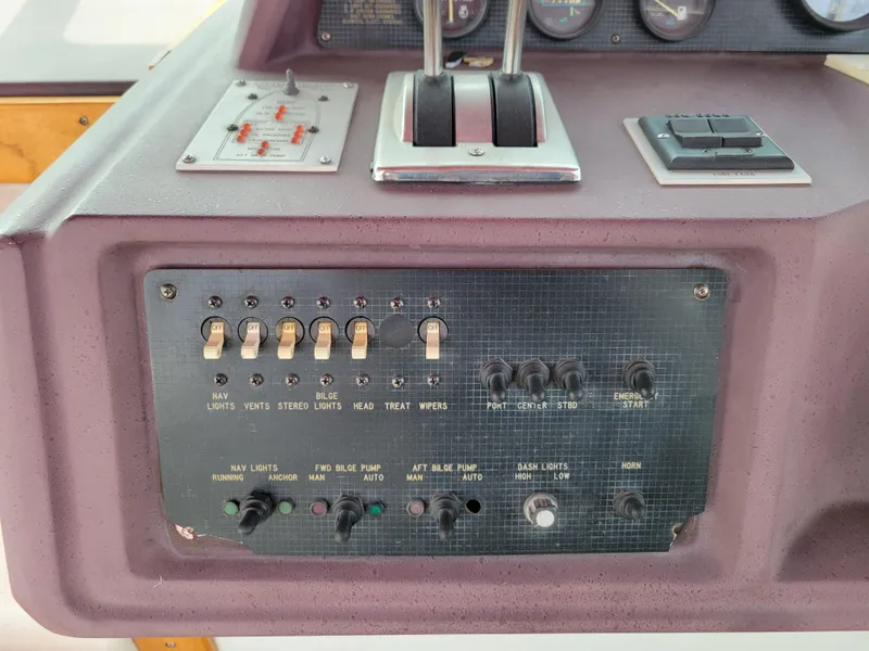 Slide: The Image of Control panel of a 1989 Sea Ray 340 Sundancer boat with switches and gauges. - 16