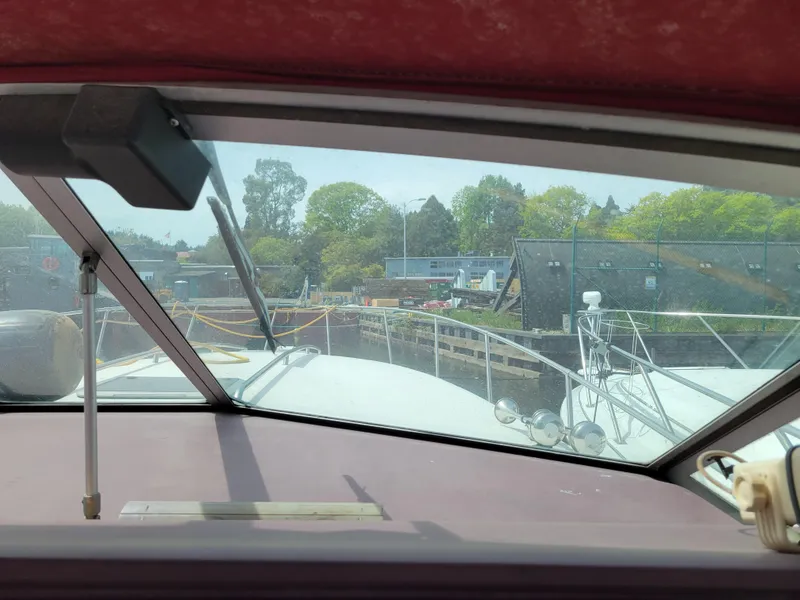 Slide: The Image of View from 1989 Sea Ray 340 Sundancer boat, docked near a marina with trees in background. - 17