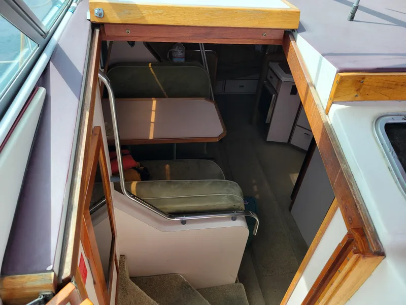 Slide: The Image of 1989 Sea Ray 340 Sundancer cabin interior with seating and table, viewed from above. - 19