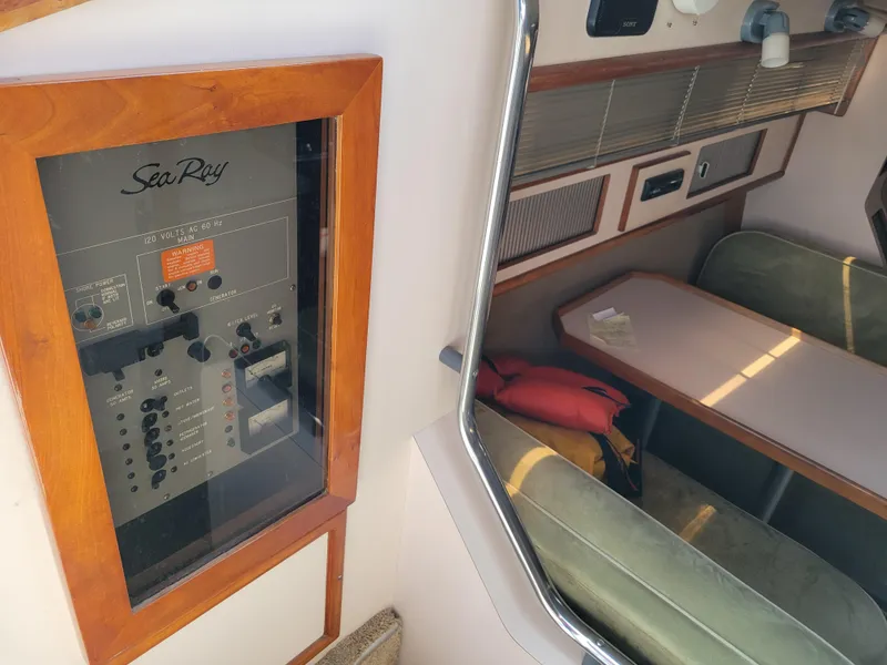 Slide: The Image of 1989 Sea Ray 340 Sundancer interior with control panel and seating area. - 21