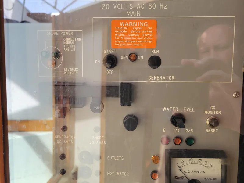 Slide: The Image of Control panel of a 1989 Sea Ray 340 Sundancer boat, showing generator and power settings. - 22