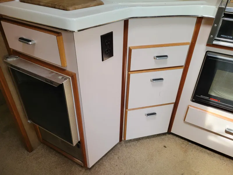 Slide: The Image of Interior of 1989 Sea Ray 340 Sundancer showing kitchen cabinetry and appliances. - 30