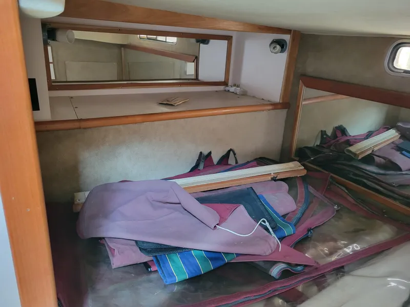 Slide: The Image of Interior cabin of 1989 Sea Ray 340 Sundancer with mirrors and stored items. - 37