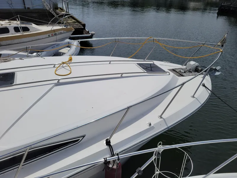 Slide: The Image of 1989 Sea Ray 340 Sundancer yacht docked at marina, featuring sleek white deck design. - 4