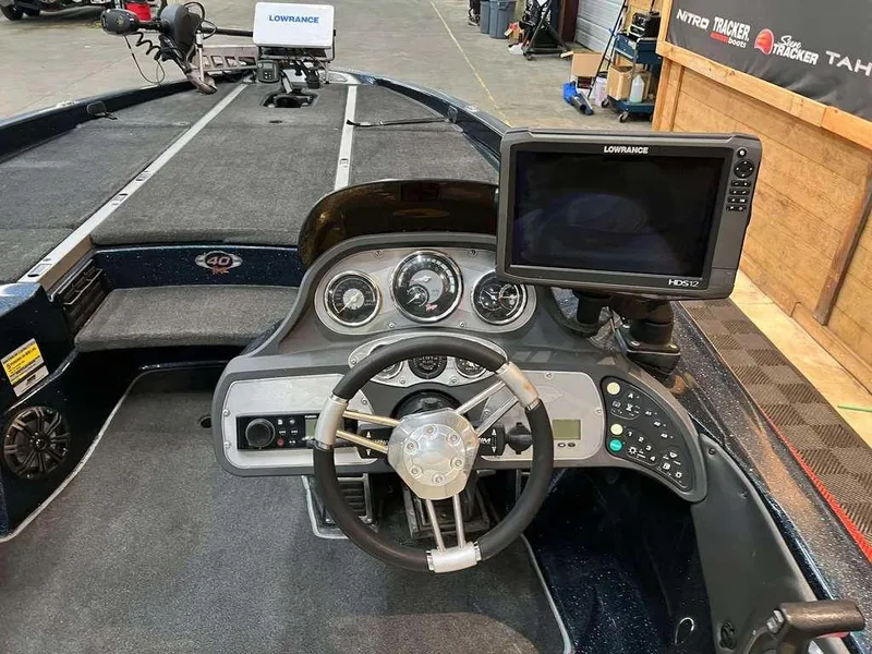 Slide: The Image of 2008 Ranger Z21 boat dashboard with steering wheel and Lowrance navigation system. - 6