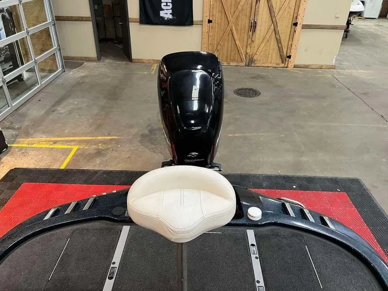 Slide: The Image of 2008 Ranger Z21 boat interior with seat and motor in a garage setting. - 9