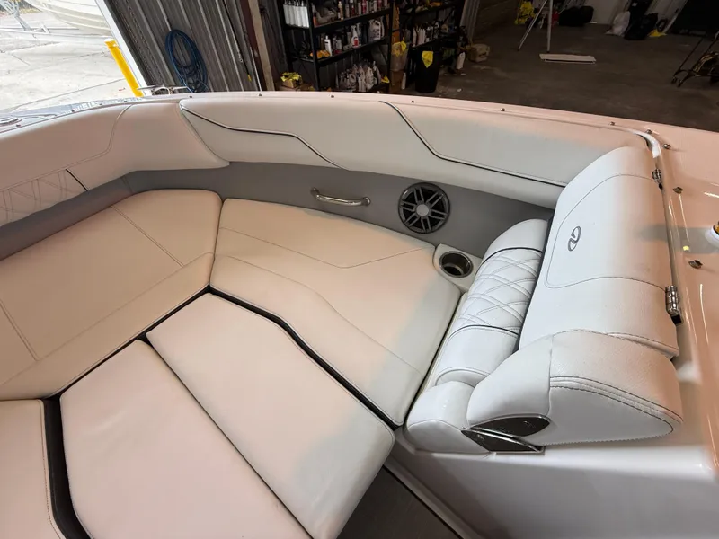 Slide: The Image of 2024 Regal LX2 boat interior with white leather seating and speaker system. - 10