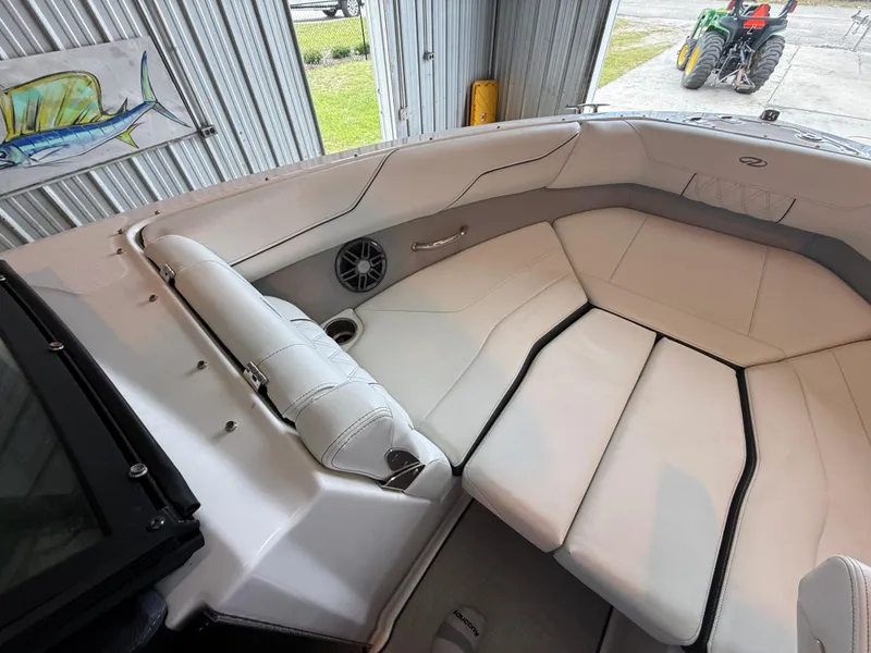 Slide: The Image of 2024 Regal LX2 boat interior with white seating and speaker. - 11