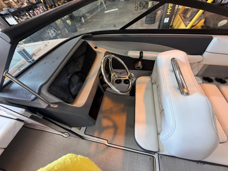 Slide: The Image of 2024 Regal LX2 boat interior with sleek dashboard and white seating. - 15