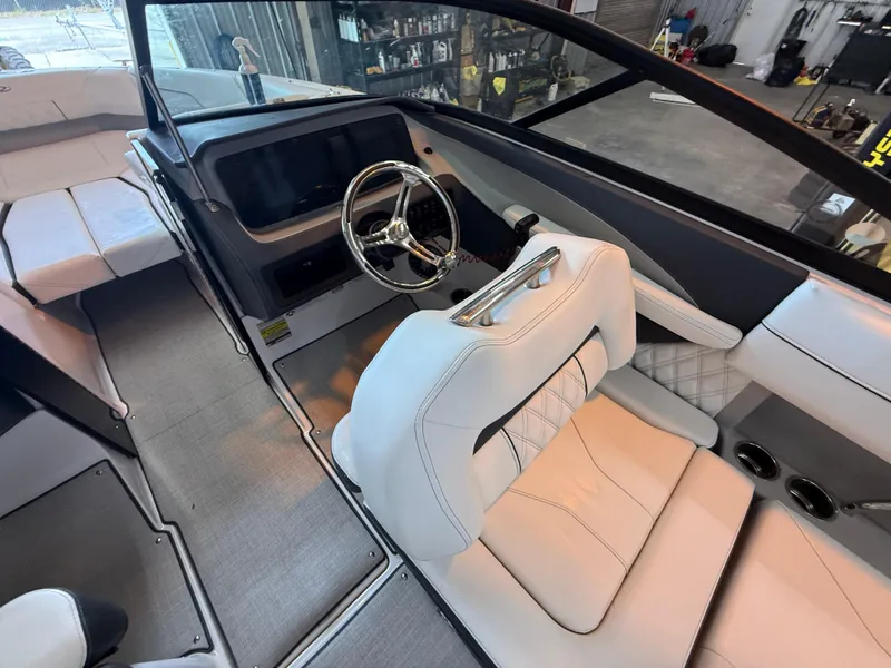 Slide: The Image of 2024 Regal LX2 boat interior with modern steering and luxurious seating. - 20