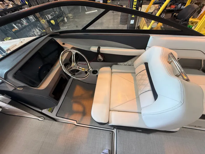 Slide: The Image of 2024 Regal LX2 boat interior with sleek steering wheel and comfortable seating. - 21