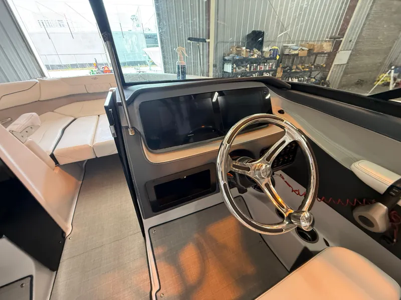 Slide: The Image of 2024 Regal LX2 boat interior with sleek steering wheel and modern seating. - 22