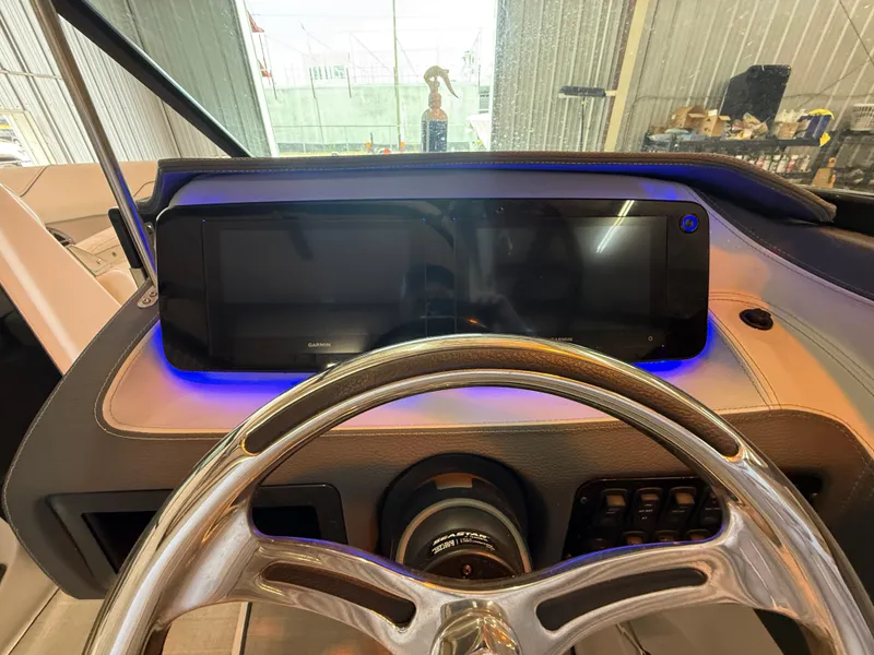 Slide: The Image of 2024 Regal LX2 boat dashboard with illuminated controls and steering wheel. - 29