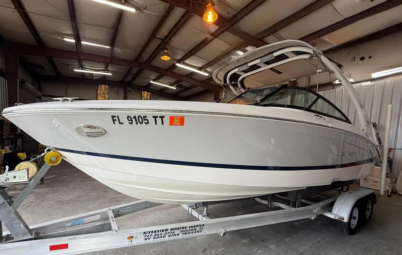 Slide: The Image of 2024 Regal LX2 boat on trailer in warehouse setting. - 4