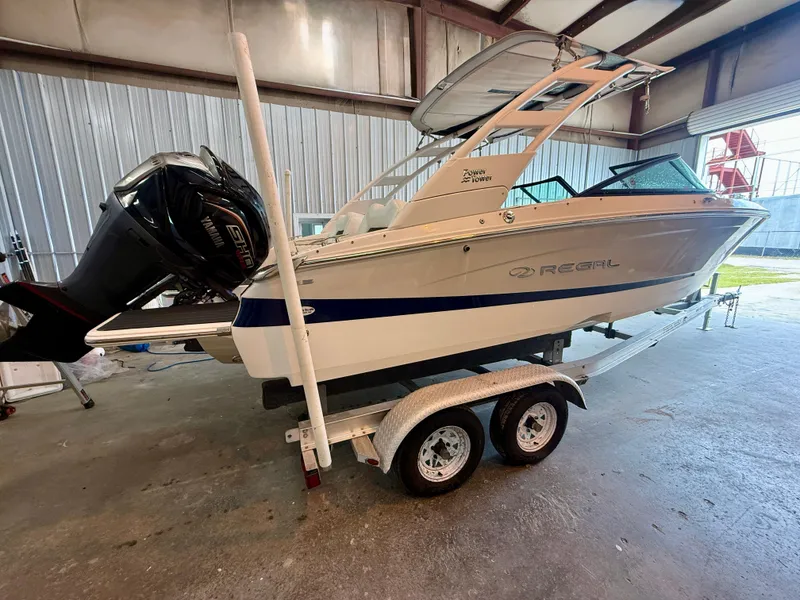 Slide: The Image of 2024 Regal LX2 boat on trailer in indoor storage facility. - 5