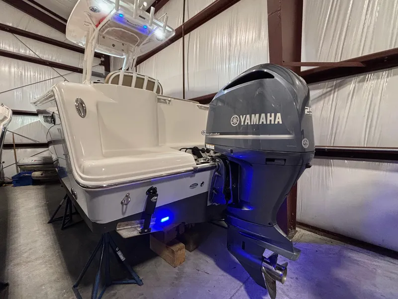 Slide: The Image of 2019 Sailfish 241 CC boat with Yamaha outboard motor in storage facility. - 11