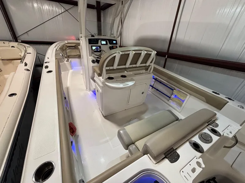 Slide: The Image of 2019 Sailfish 241 CC boat interior with modern console and seating in a storage facility. - 27