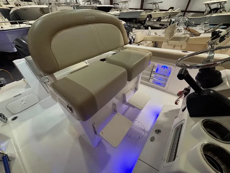 Slide: The Image of 2019 Sailfish 241 CC boat interior with dual seats and illuminated deck. - 32