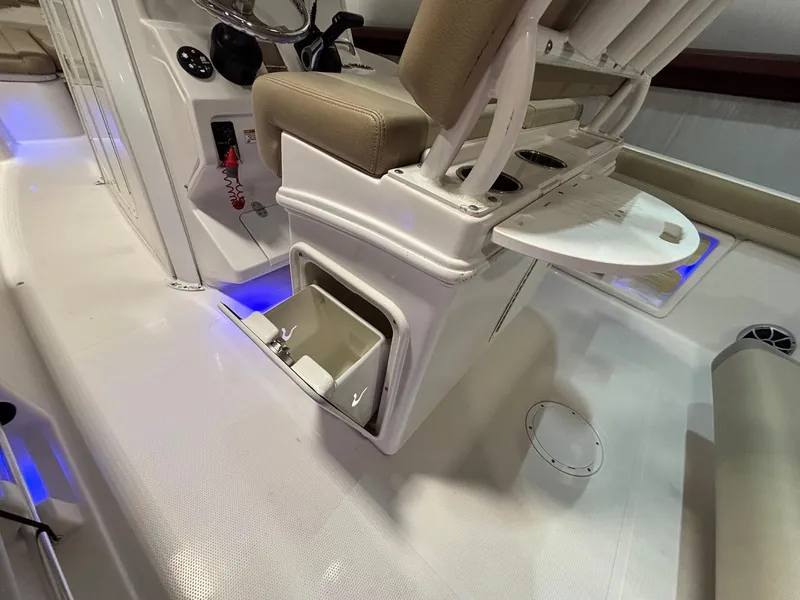 Slide: The Image of 2019 Sailfish 241 CC boat interior with storage compartment and seating. - 33