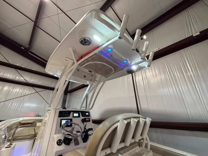 Slide: The Image of 2019 Sailfish 241 CC boat interior with steering console and rod holders. - 36