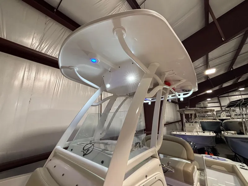 Slide: The Image of 2019 Sailfish 241 CC boat interior with T-top and LED lighting in a showroom. - 39