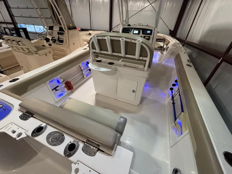 Slide: The Image of 2019 Sailfish 241 CC boat interior with seating, control panel, and blue LED lighting. - 40