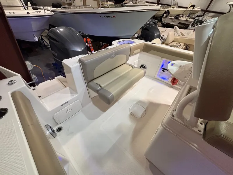 Slide: The Image of 2019 Sailfish 241 CC boat interior with seating and storage compartments. - 41