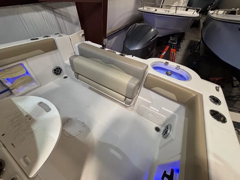 Slide: The Image of 2019 Sailfish 241 CC boat interior with seating and storage compartments. - 42
