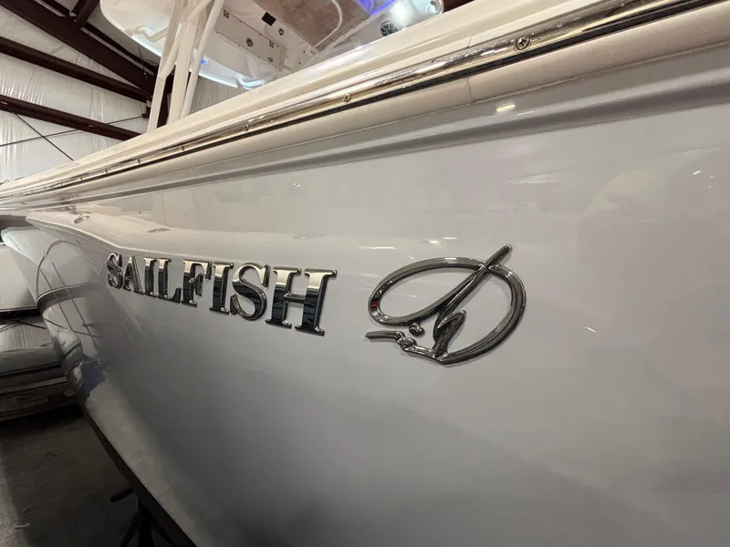 Slide: The Image of 2019 Sailfish 241 CC boat side view with logo in a storage facility. - 6