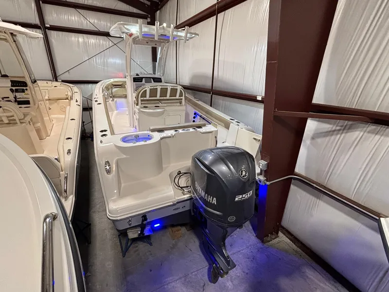 Slide: The Image of 2019 Sailfish 241 CC boat with Yamaha 250 engine in storage facility. - 8