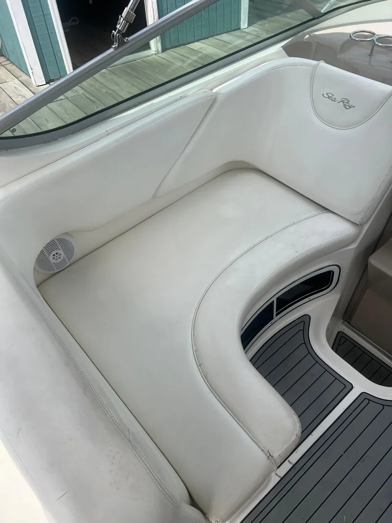 Slide: The Image of 2005 Sea Ray 280 Sundancer interior seating with white upholstery and sleek design. - 13