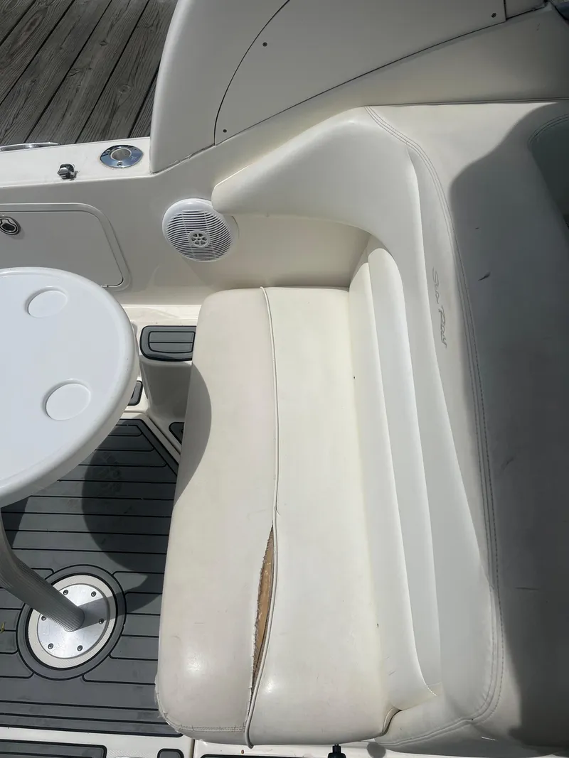 Slide: The Image of 2005 Sea Ray 280 Sundancer boat interior with white seating and table. - 14