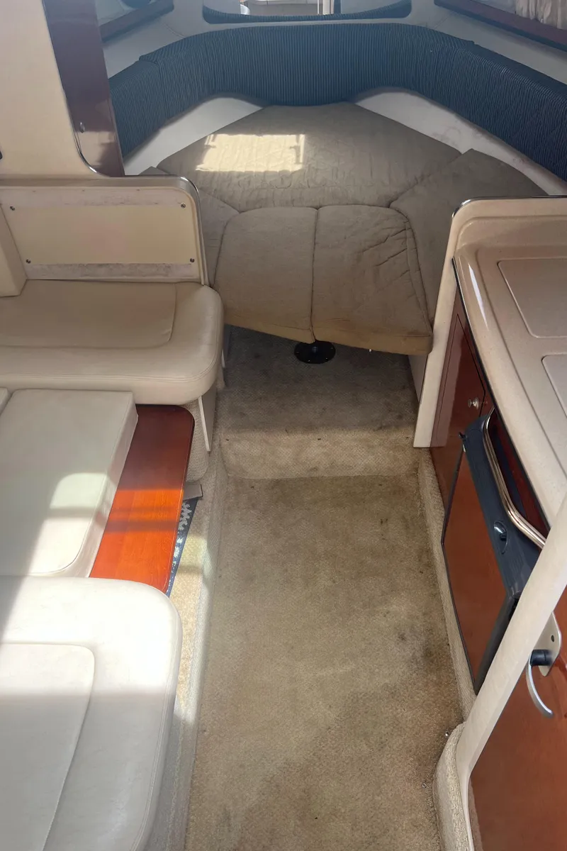 Slide: The Image of Interior of 2005 Sea Ray 280 Sundancer, featuring cozy cabin and seating area. - 16